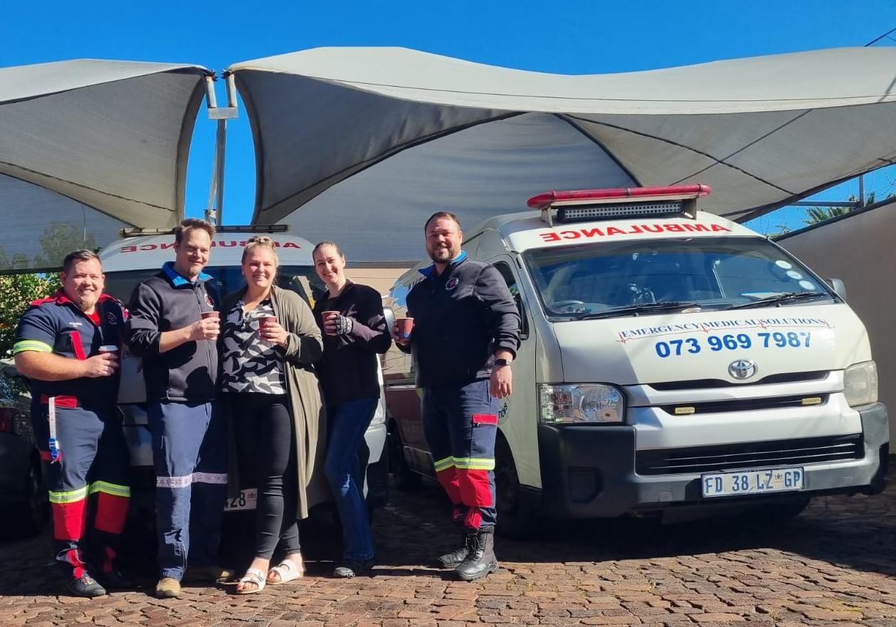Emergency Medical Solutions team standing with their ambulances